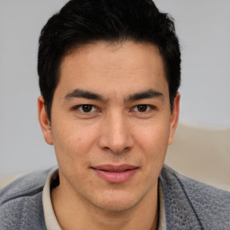 Joyful latino young-adult male with short  brown hair and brown eyes