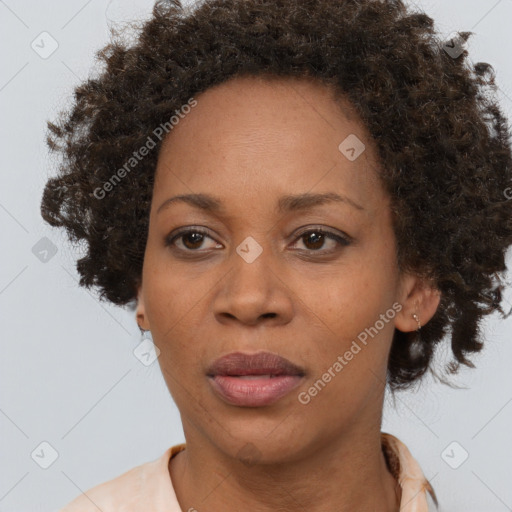 Joyful black adult female with short  brown hair and brown eyes