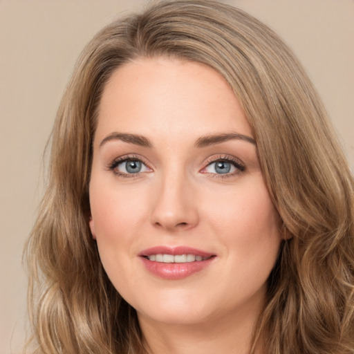 Joyful white young-adult female with long  brown hair and green eyes