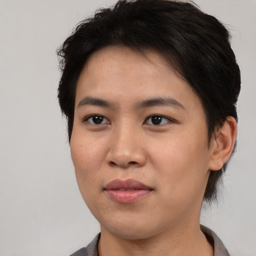 Joyful asian young-adult female with short  brown hair and brown eyes