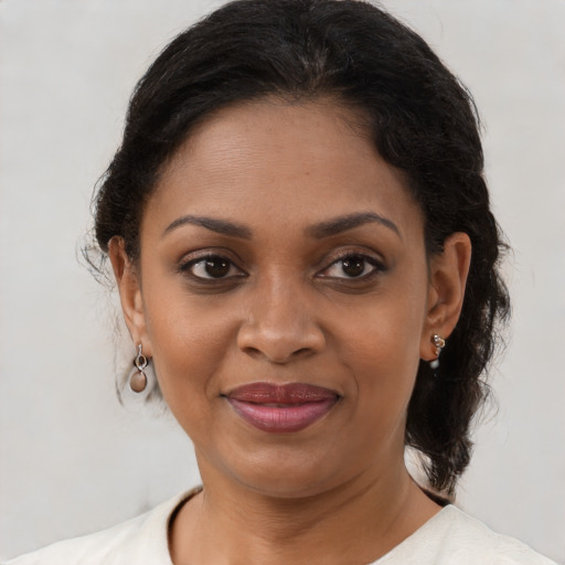 Joyful black adult female with medium  brown hair and brown eyes