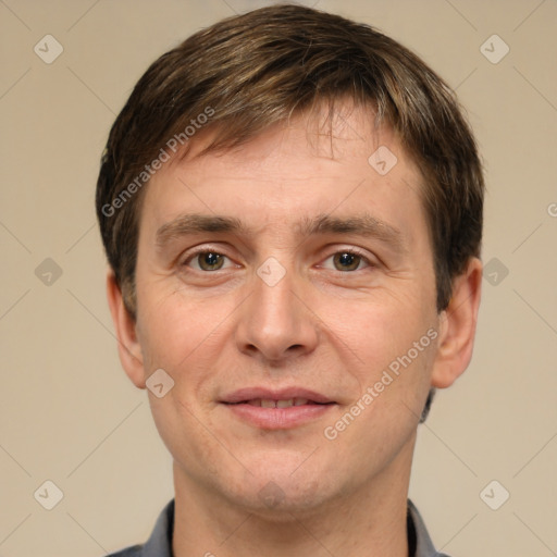 Joyful white adult male with short  brown hair and grey eyes