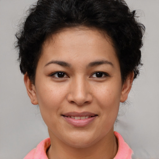 Joyful latino young-adult female with short  brown hair and brown eyes