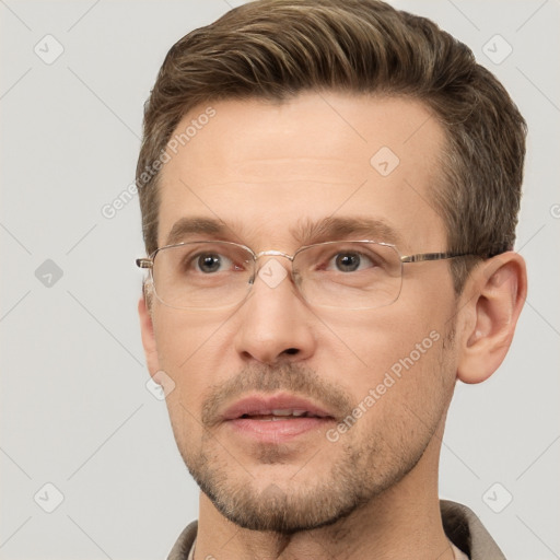 Joyful white adult male with short  brown hair and brown eyes