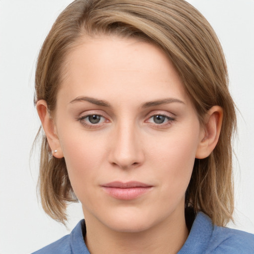 Joyful white young-adult female with medium  brown hair and blue eyes