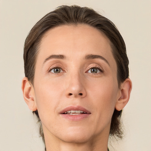 Joyful white adult female with medium  brown hair and grey eyes