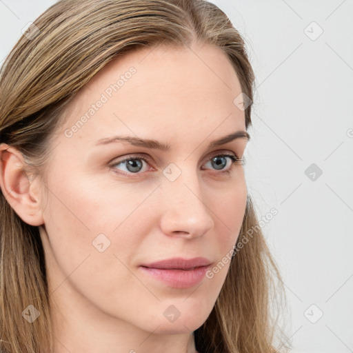 Joyful white young-adult female with long  brown hair and blue eyes