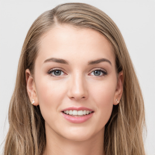 Joyful white young-adult female with long  brown hair and grey eyes