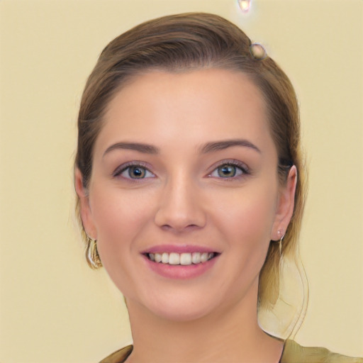 Joyful white young-adult female with long  brown hair and blue eyes