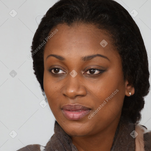 Joyful black young-adult female with long  brown hair and brown eyes