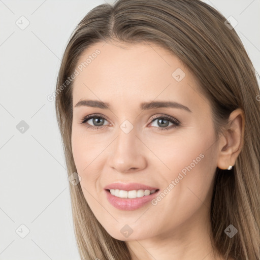 Joyful white young-adult female with long  brown hair and brown eyes