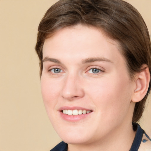 Joyful white young-adult female with medium  brown hair and grey eyes