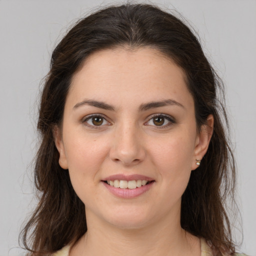 Joyful white young-adult female with medium  brown hair and brown eyes