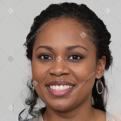 Joyful black young-adult female with medium  black hair and brown eyes