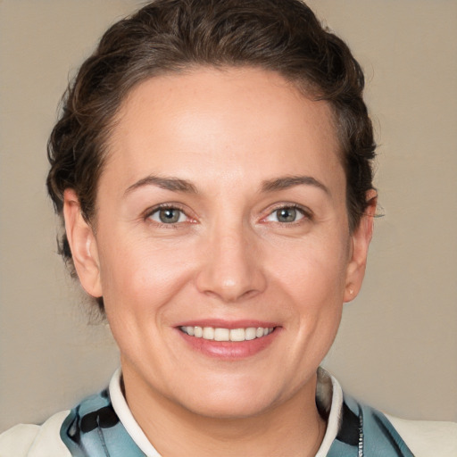 Joyful white adult female with short  brown hair and grey eyes