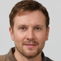 Joyful white adult male with short  brown hair and grey eyes