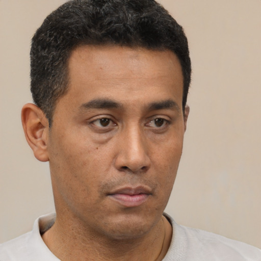 Neutral latino young-adult male with short  black hair and brown eyes