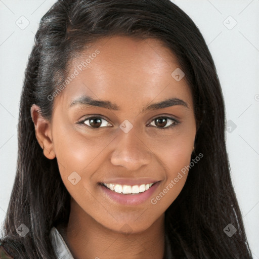 Joyful black young-adult female with long  brown hair and brown eyes