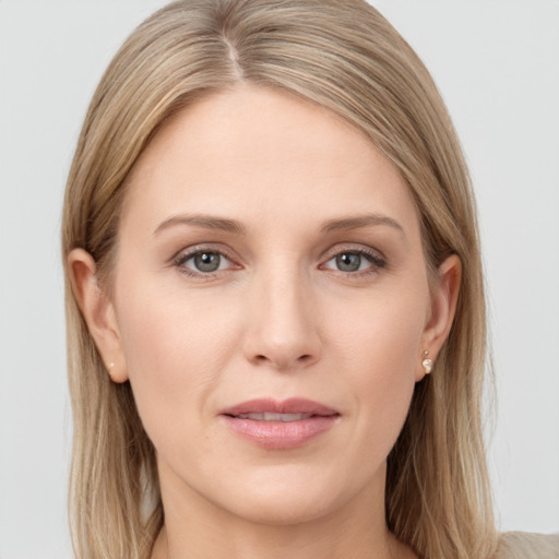 Joyful white young-adult female with long  brown hair and grey eyes