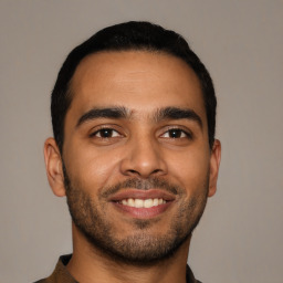 Joyful latino young-adult male with short  black hair and brown eyes