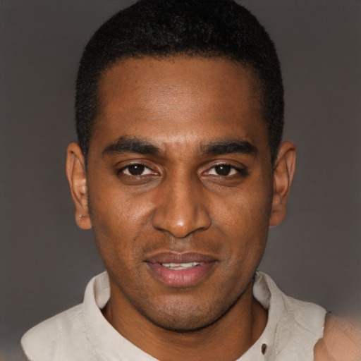 Joyful black young-adult male with short  black hair and brown eyes
