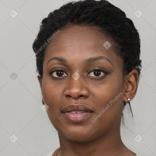 Joyful black young-adult female with short  black hair and brown eyes