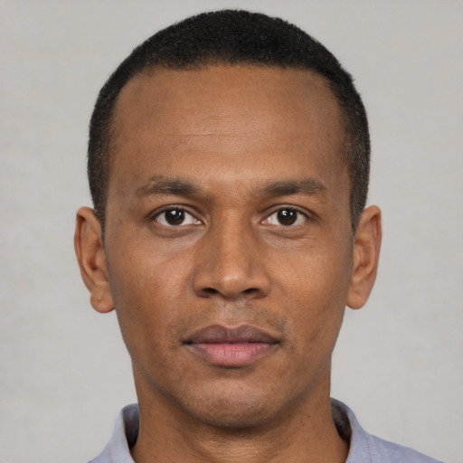 Neutral latino adult male with short  black hair and brown eyes