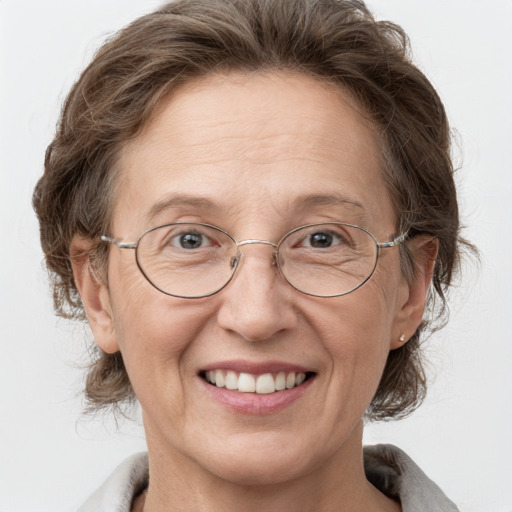 Joyful white middle-aged female with medium  brown hair and grey eyes