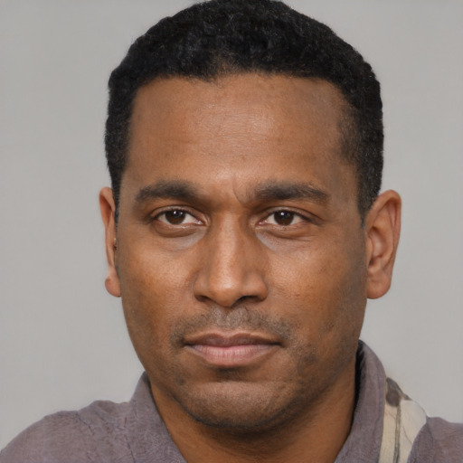 Neutral latino adult male with short  black hair and brown eyes