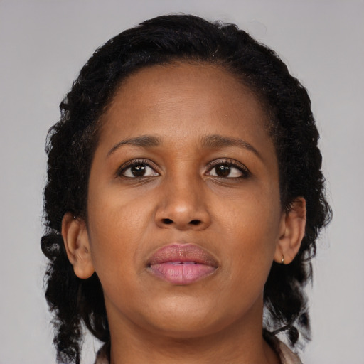 Neutral black young-adult female with medium  brown hair and brown eyes