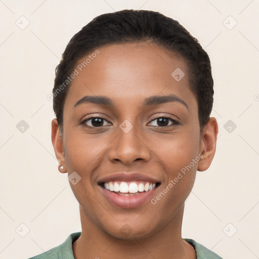 Joyful latino young-adult female with short  brown hair and brown eyes