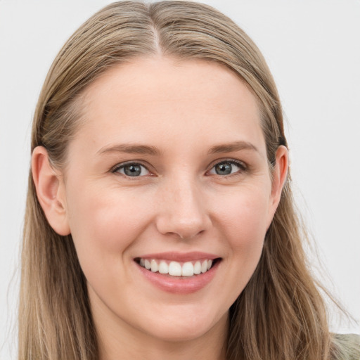 Joyful white young-adult female with long  brown hair and blue eyes