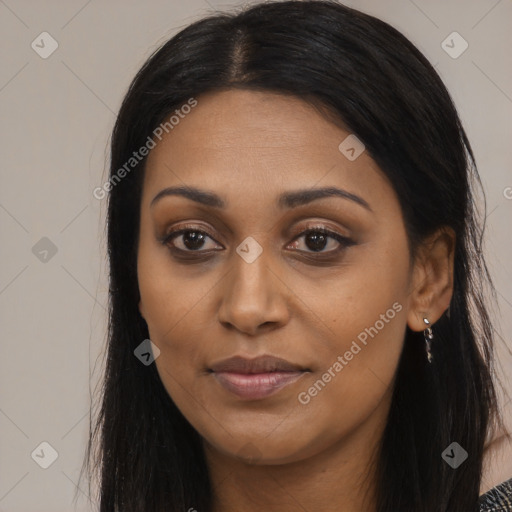 Joyful black young-adult female with long  black hair and brown eyes