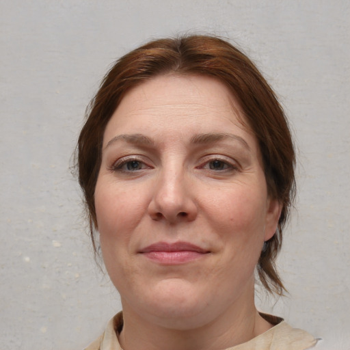 Joyful white adult female with medium  brown hair and brown eyes