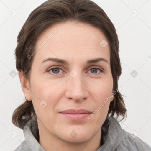 Joyful white adult female with medium  brown hair and grey eyes