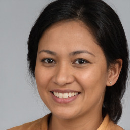 Joyful white adult female with medium  brown hair and brown eyes