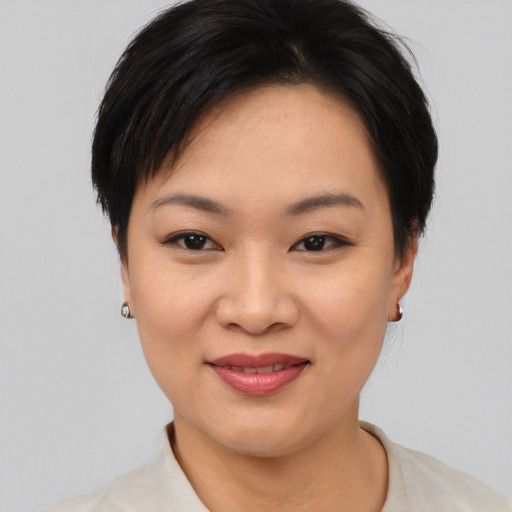 Joyful asian young-adult female with short  black hair and brown eyes