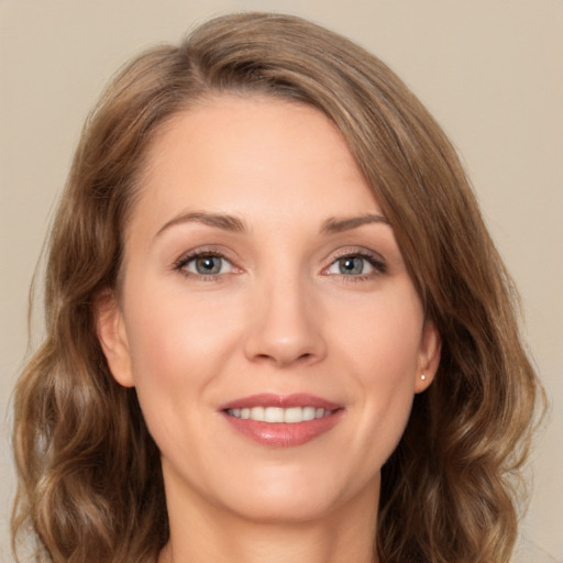 Joyful white young-adult female with medium  brown hair and green eyes