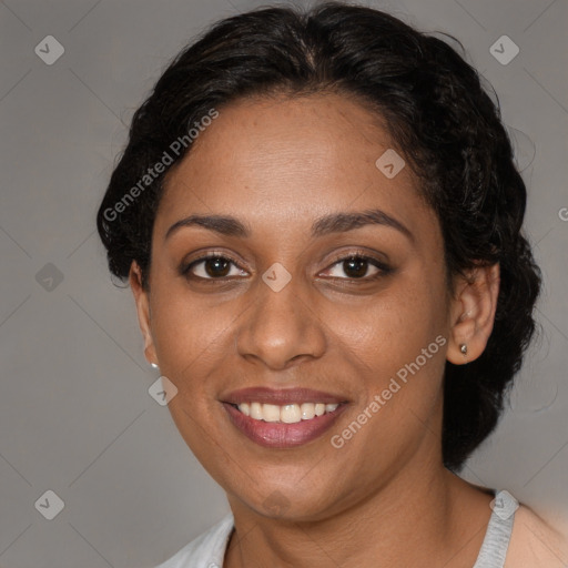 Joyful black adult female with short  brown hair and brown eyes