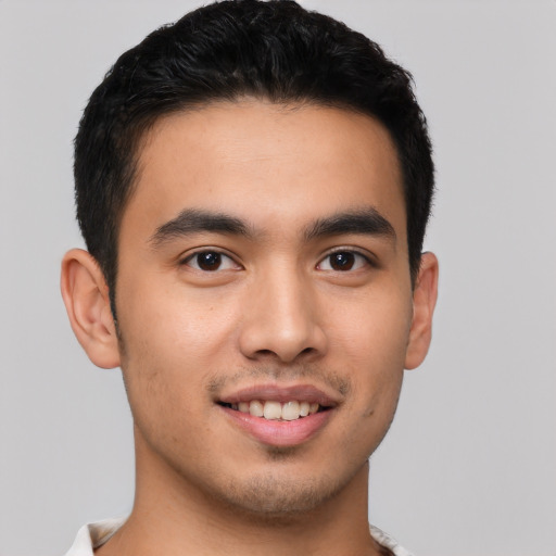 Joyful latino young-adult male with short  brown hair and brown eyes