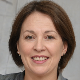 Joyful white adult female with medium  brown hair and brown eyes