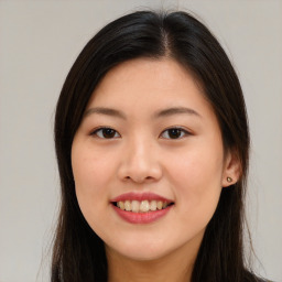 Joyful asian young-adult female with long  brown hair and brown eyes