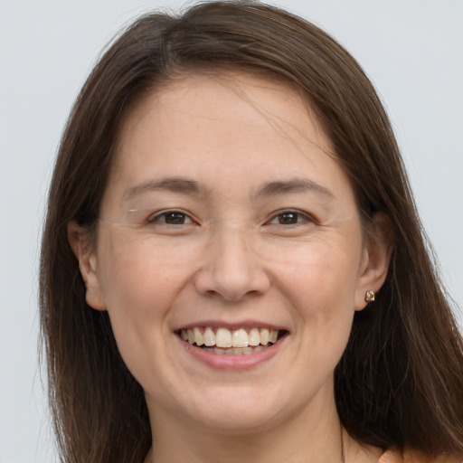 Joyful white young-adult female with long  brown hair and grey eyes
