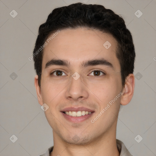 Joyful white young-adult male with short  black hair and brown eyes