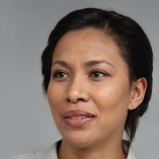 Joyful black adult female with medium  black hair and brown eyes