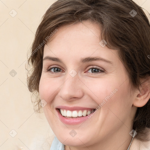 Joyful white young-adult female with medium  brown hair and green eyes