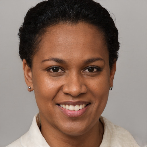 Joyful black young-adult female with short  brown hair and brown eyes