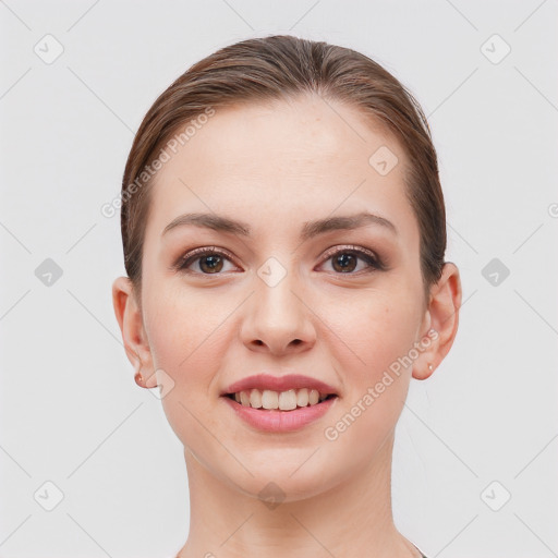 Joyful white young-adult female with short  brown hair and grey eyes