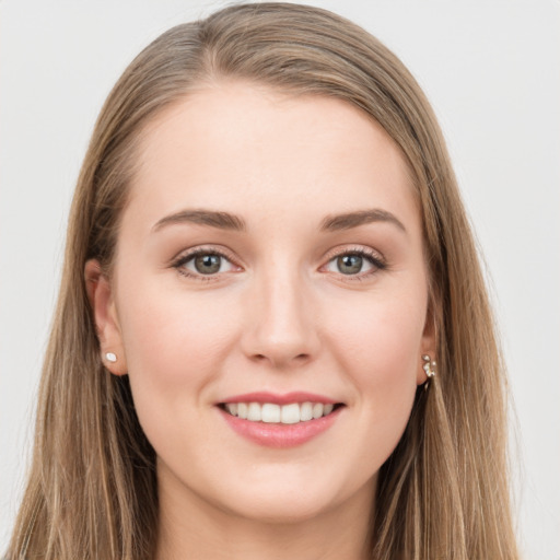 Joyful white young-adult female with long  brown hair and grey eyes