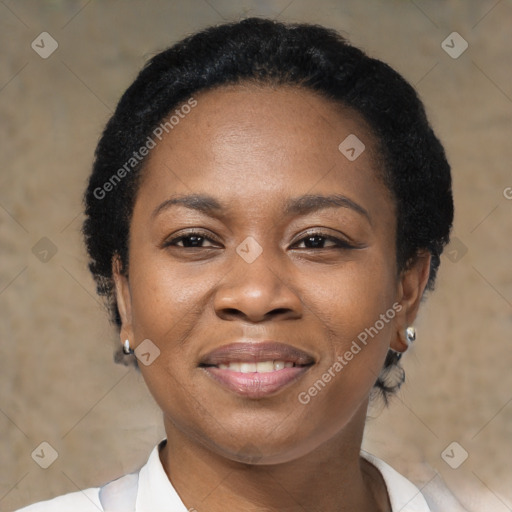 Joyful black young-adult female with short  black hair and brown eyes